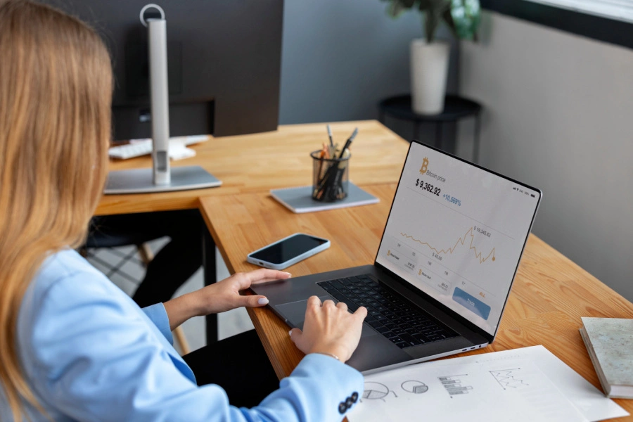Business professional analyzing financial data on a laptop.