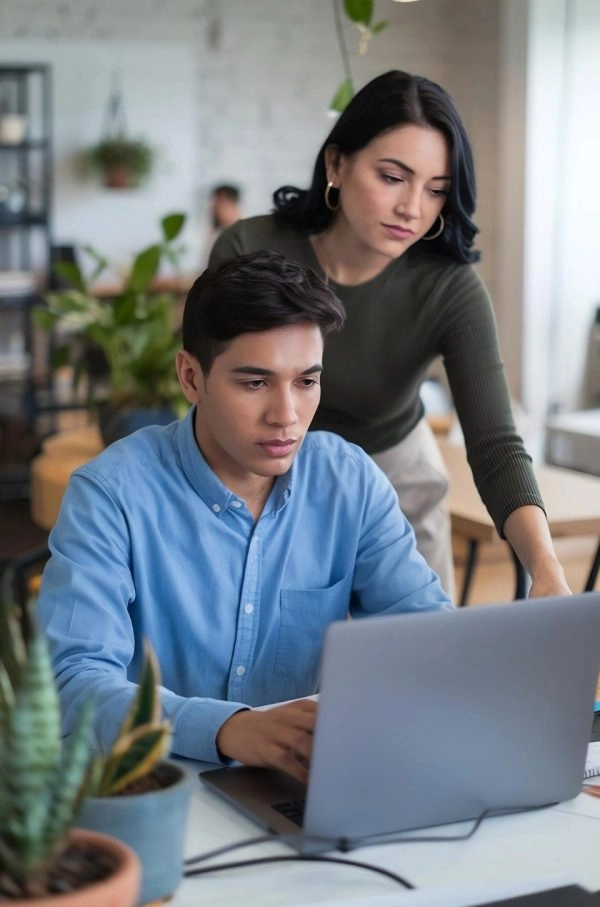 Business professionals working together on a laptop.
